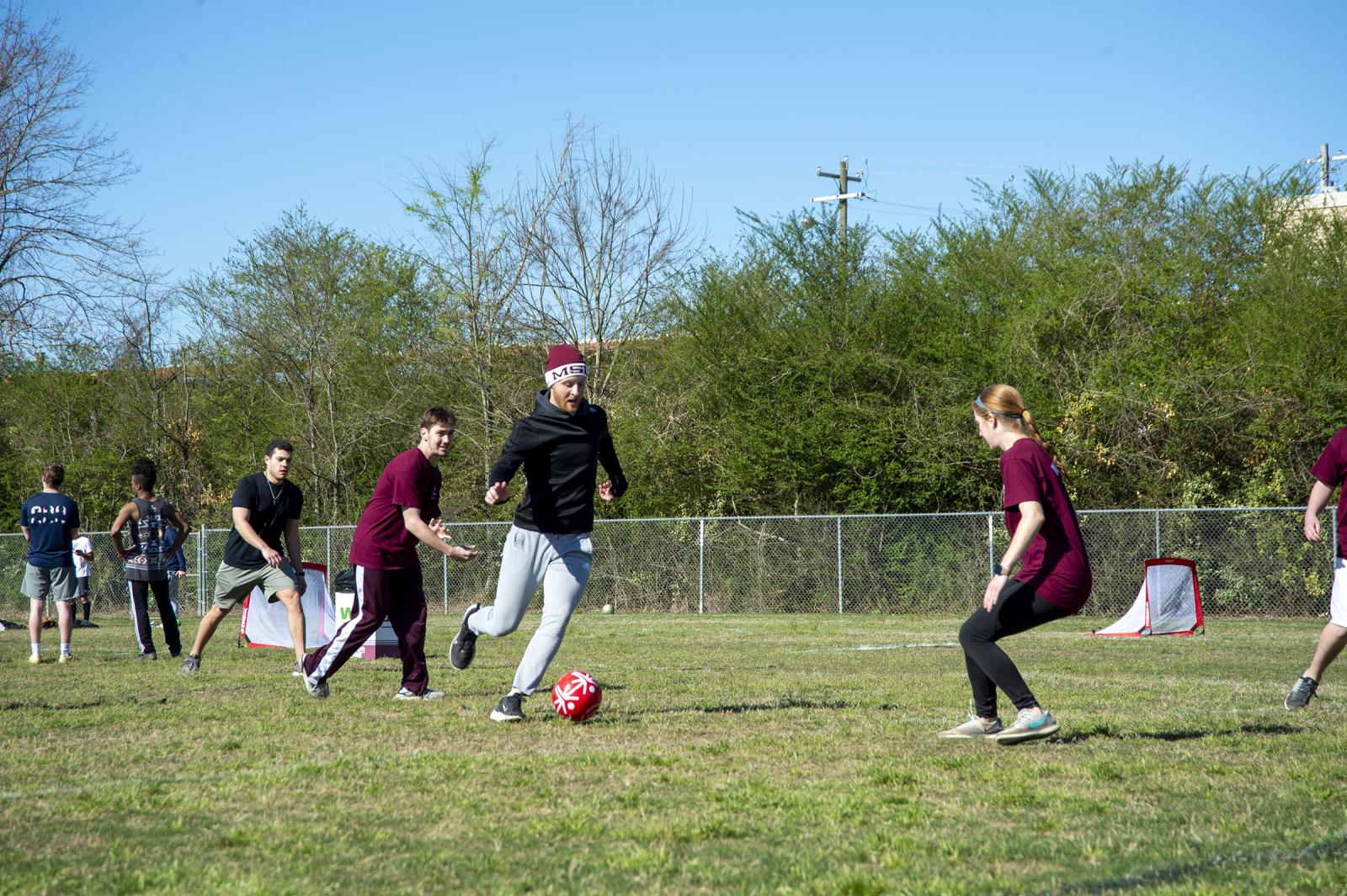 Students playing soccer on a field