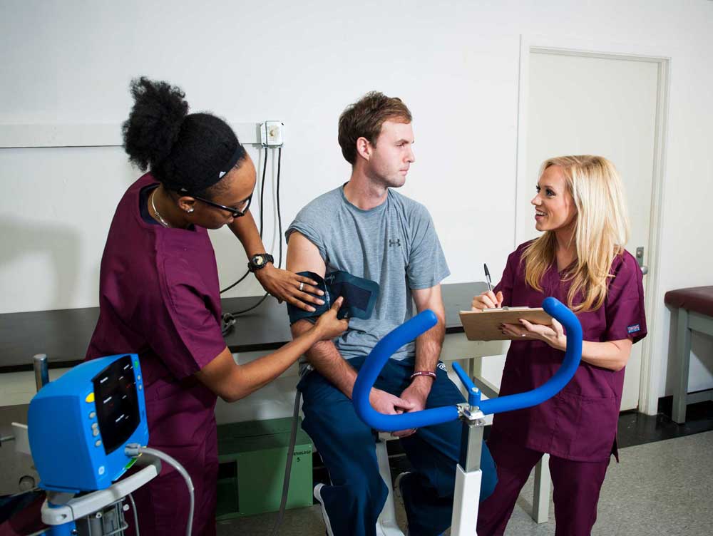 Students running stress tests on patient