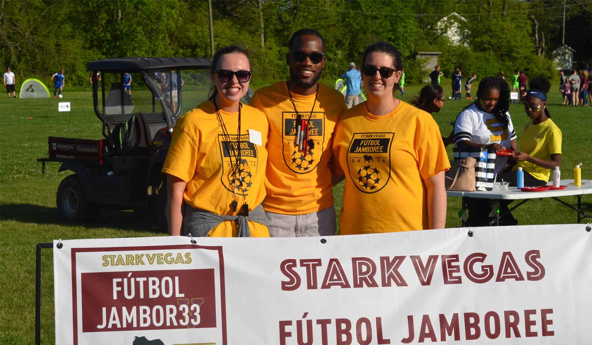 3 women holding a futbol sign