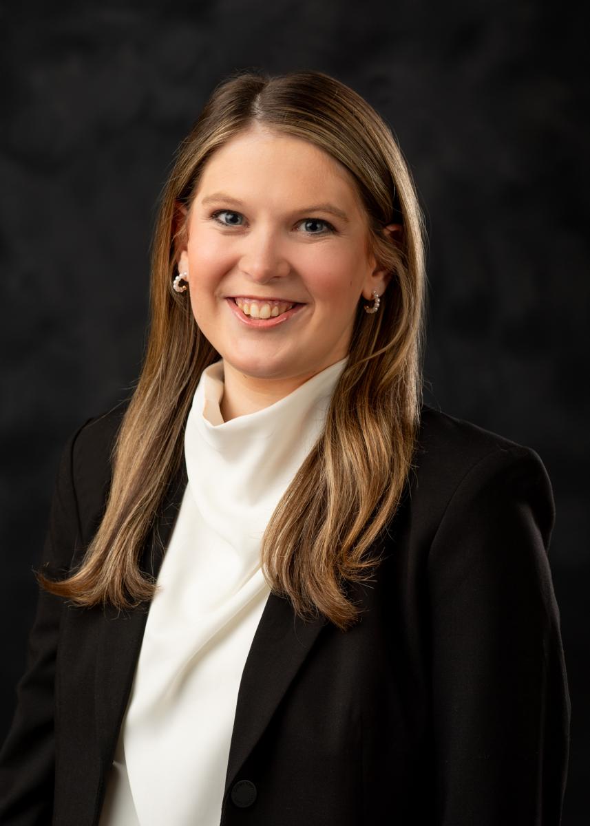 Female - wearing white blouse with black jacket